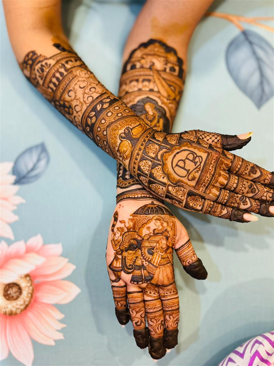 Intricate full-arm bridal mehandi with initials