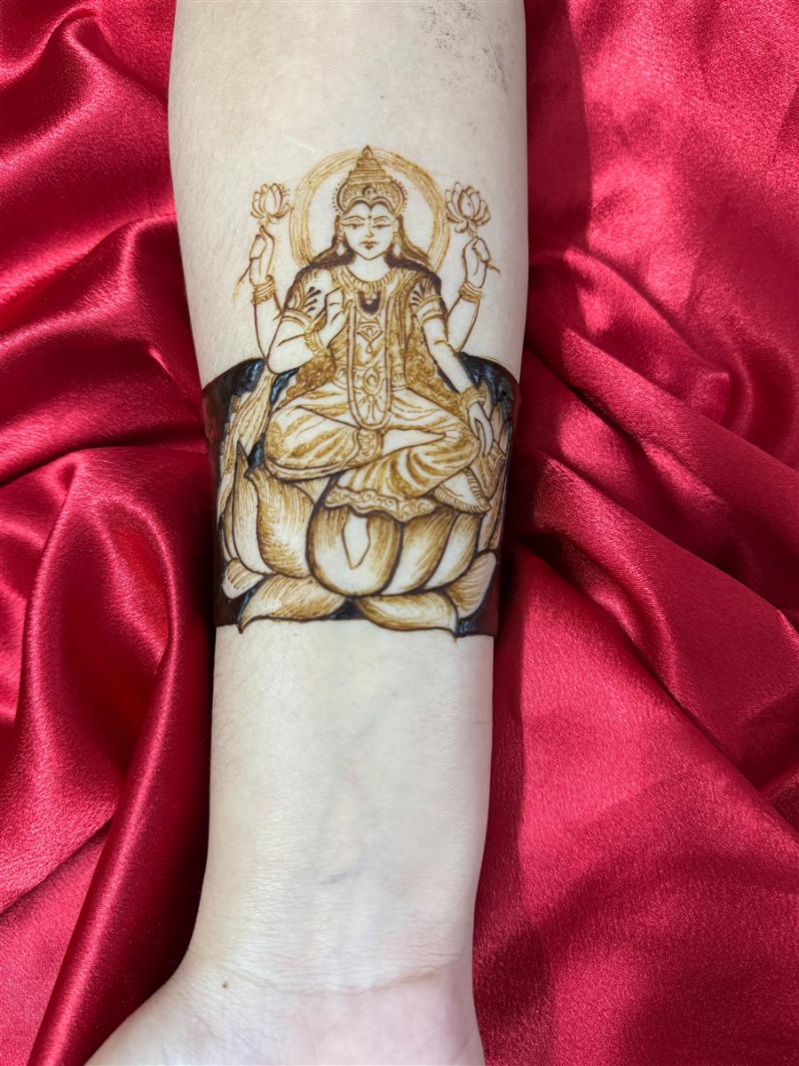 Goddess Lakshmi on lotus drawn on a forearm