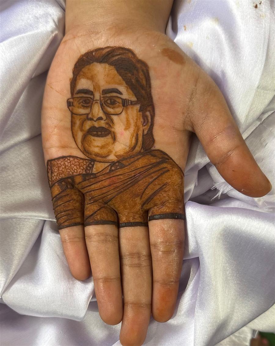 Grandmother's portrait in henna on a child's palm